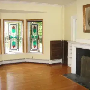 Stained glass bay windows, fireplace, and hardwood floors