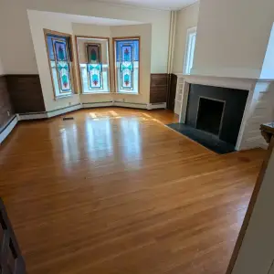 Stained glass bay windows, fireplace, and hardwood floors